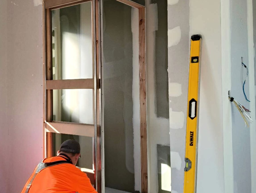 OBS installer preparing a clean ORI door opening on site
